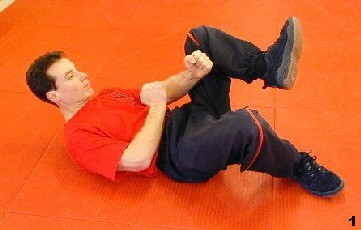 Wing Tsun Exercise 72, Fig. 1 - Sifu bends his leg, the other is resting on the ground