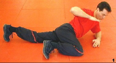 Wing Tsun Course, Fig. 2 - Sifu is lying on the foor bending his right leg