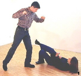 Wing Tsun Exercise 88, Fig. 1 - Melanie is beeing kicked form the side.